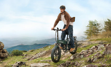 a man riding an engwe engine pro 2.0 downhill ebike down the mountain