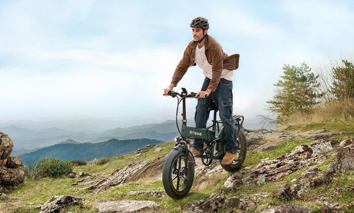 a man riding an engwe engine pro 2.0 downhill ebike down the mountain